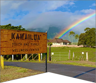 Kawailoa Youth and Family Wellness Center sign in front of rainbow